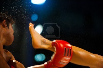 8449008-bangkok–october-12-a-kick-catches-the-head-of-a-muay-thai-boxer-and-sends-sweat-flying-through-the-